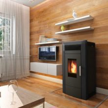 A black Commo 21 boiler pellet stove in the modern room.
