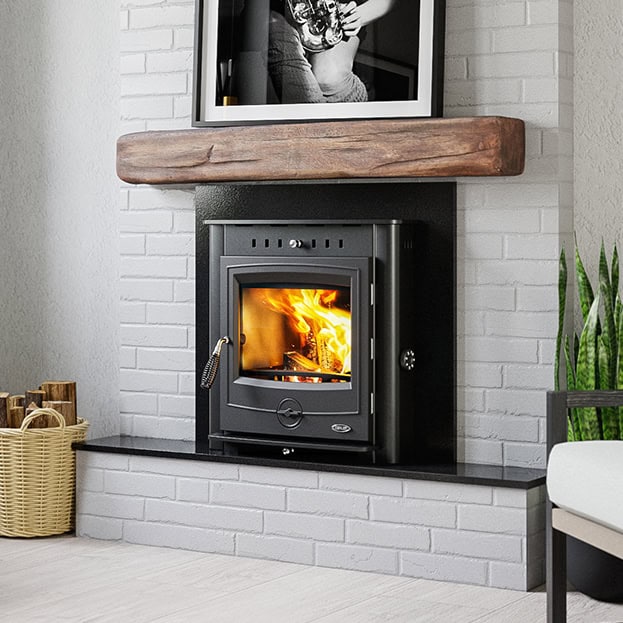 Henley achill 17 inset boiler stove in a fireplace.