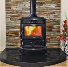 Black Enamel Olymberyl Aidan stove on a black hearth.