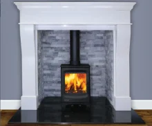 Atlantic Pearl 5 Wide stove in an alcove surrounded by a marble white frame.